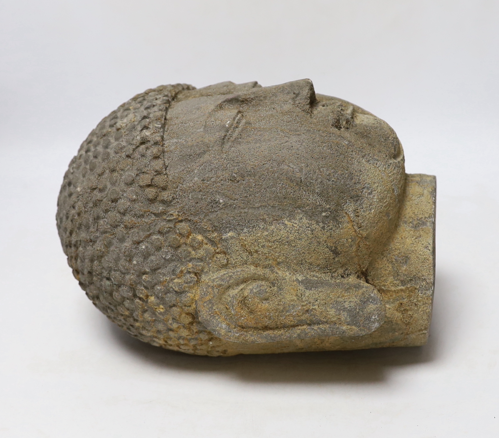 A reconstituted stone model of Buddha’s head, 25cm